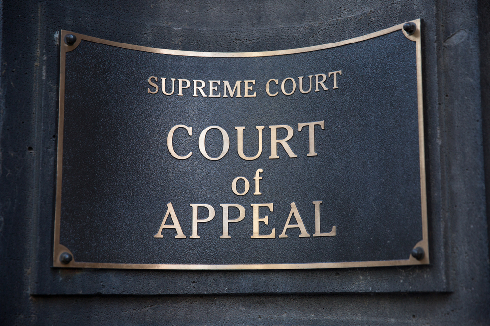 A "Court of Appeal" sign mounted on a wall.