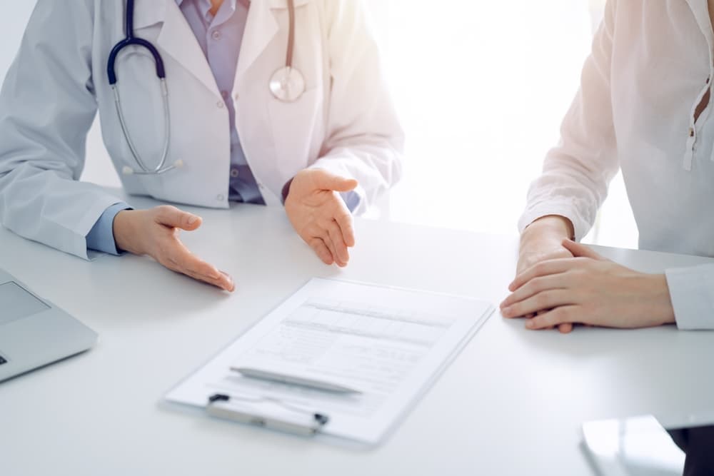 Doctor and patient reviewing medical records