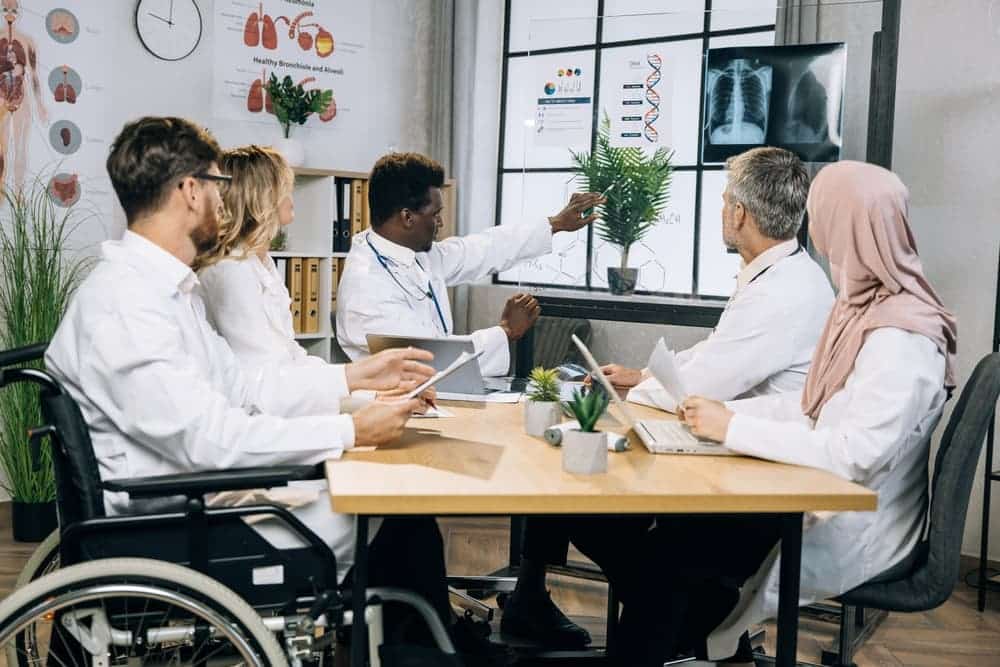 Experienced medical experts talking about progress in medicine and disability