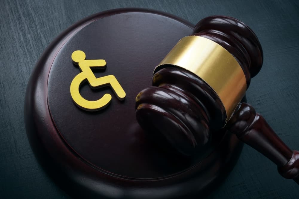Disabled person sign and gavel. Disability law